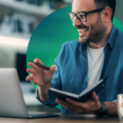 man, glasses, beard, smiling, laptop, pen, book, business rates assessment